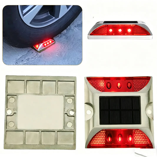 Tacha solar LED roja instalada para señalización junto a una rueda